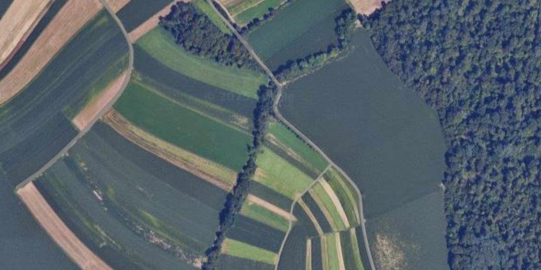 A Google Maps view of the area during summer shows fields with various crops. The visual diversity illustrates the implementation of crop rotation in practice.
