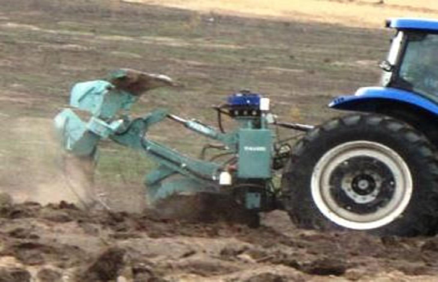 The Delfino3 plough at work. The picture shows the moment in which, after digging a micro bassin, the plowshare is coming out of the soil while the two rippers are going deeper in creating the underground water bag.